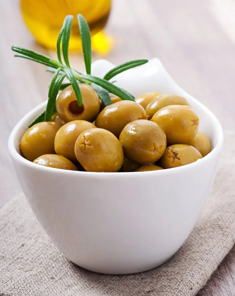 Green olive in bowl.